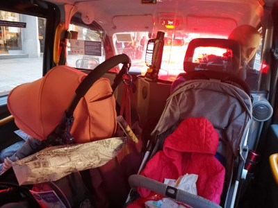 Two strollers in London cab